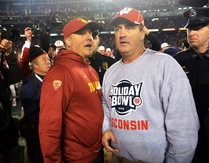 Paul Chryst speaking with USC head coach Clay Helton after the Holiday Bowl.